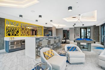 A clubhouse with a pool table and a bar